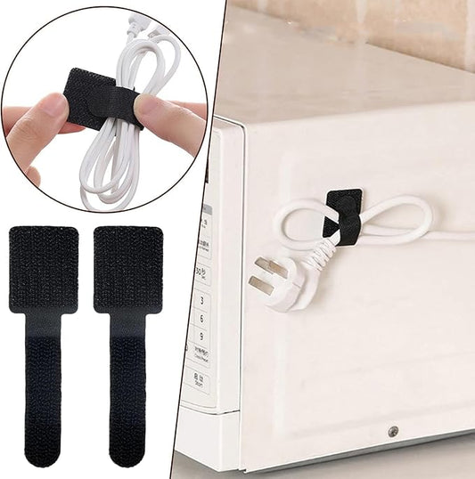 Black cable ties holding a white cable to a device, with close-up of hand using tie.