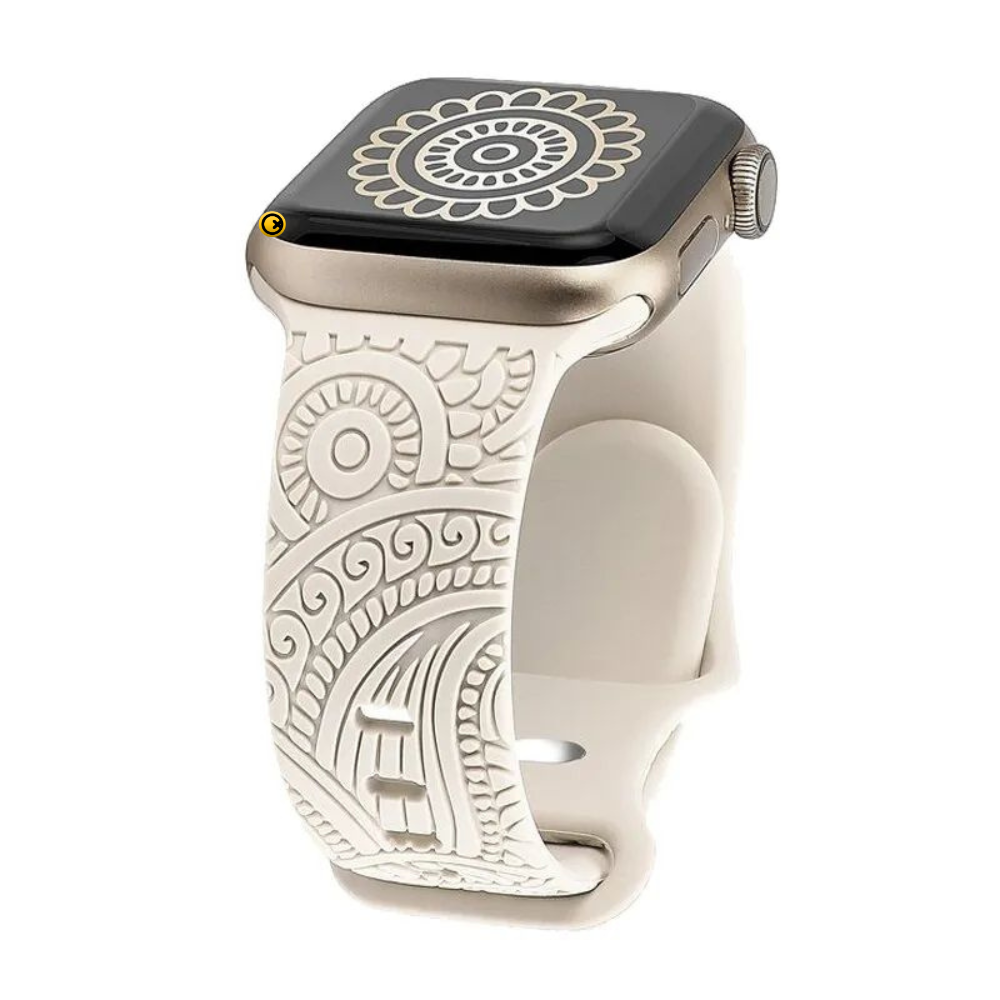 Close-up of starlight beige engraved mandala paisley silicone Apple Watch band with intricate bohemian floral pattern and gold aluminum Apple Watch case