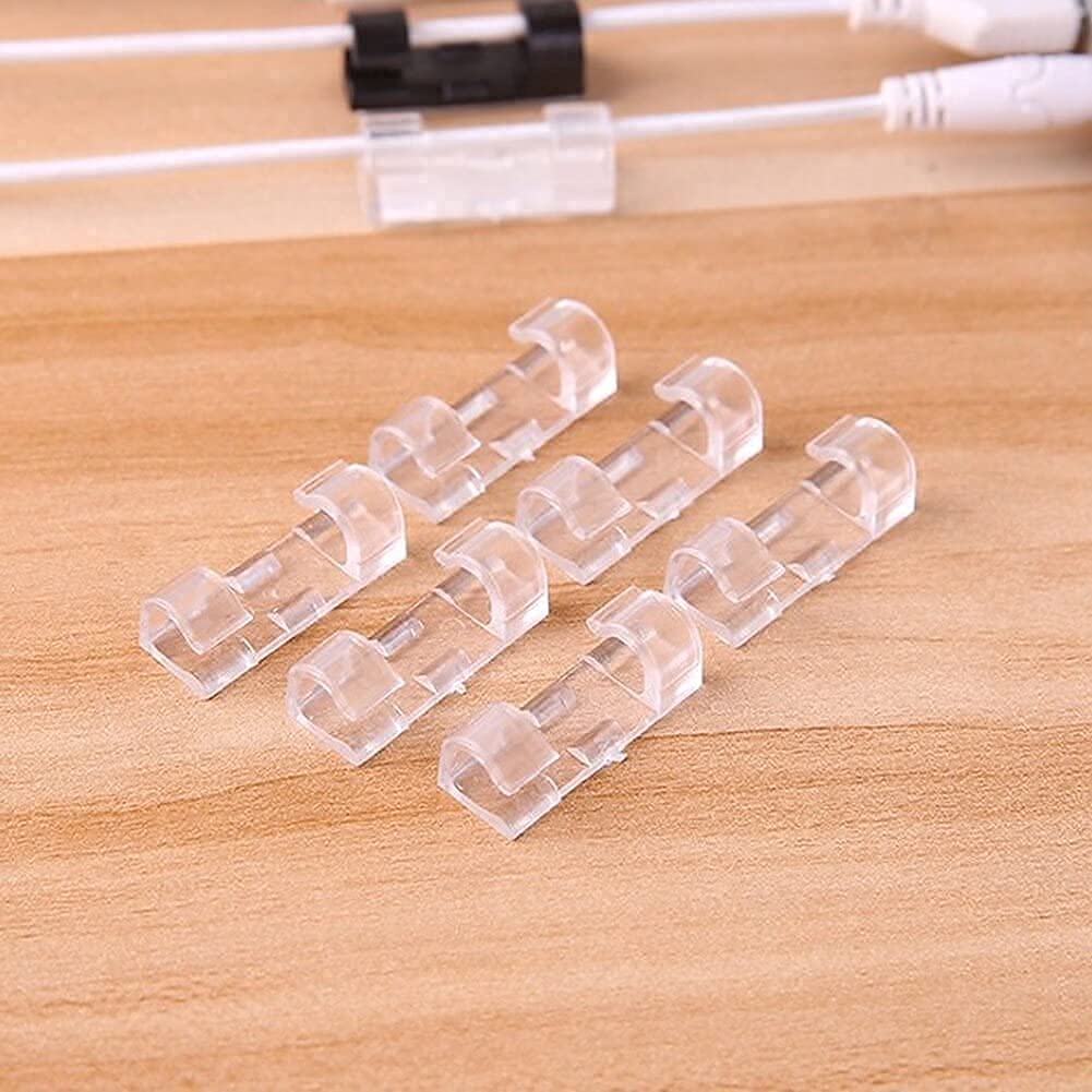 Clear cable clips on a wooden surface
