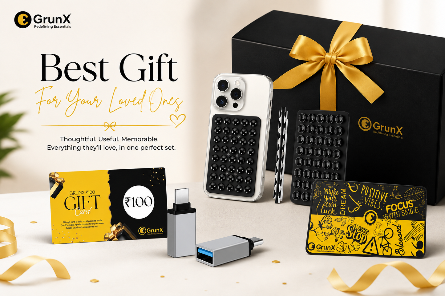 GrunX gift box for loved ones featuring ₹100 gift card, phone case, USB-C adapters, and accessory card in premium black and gold packaging