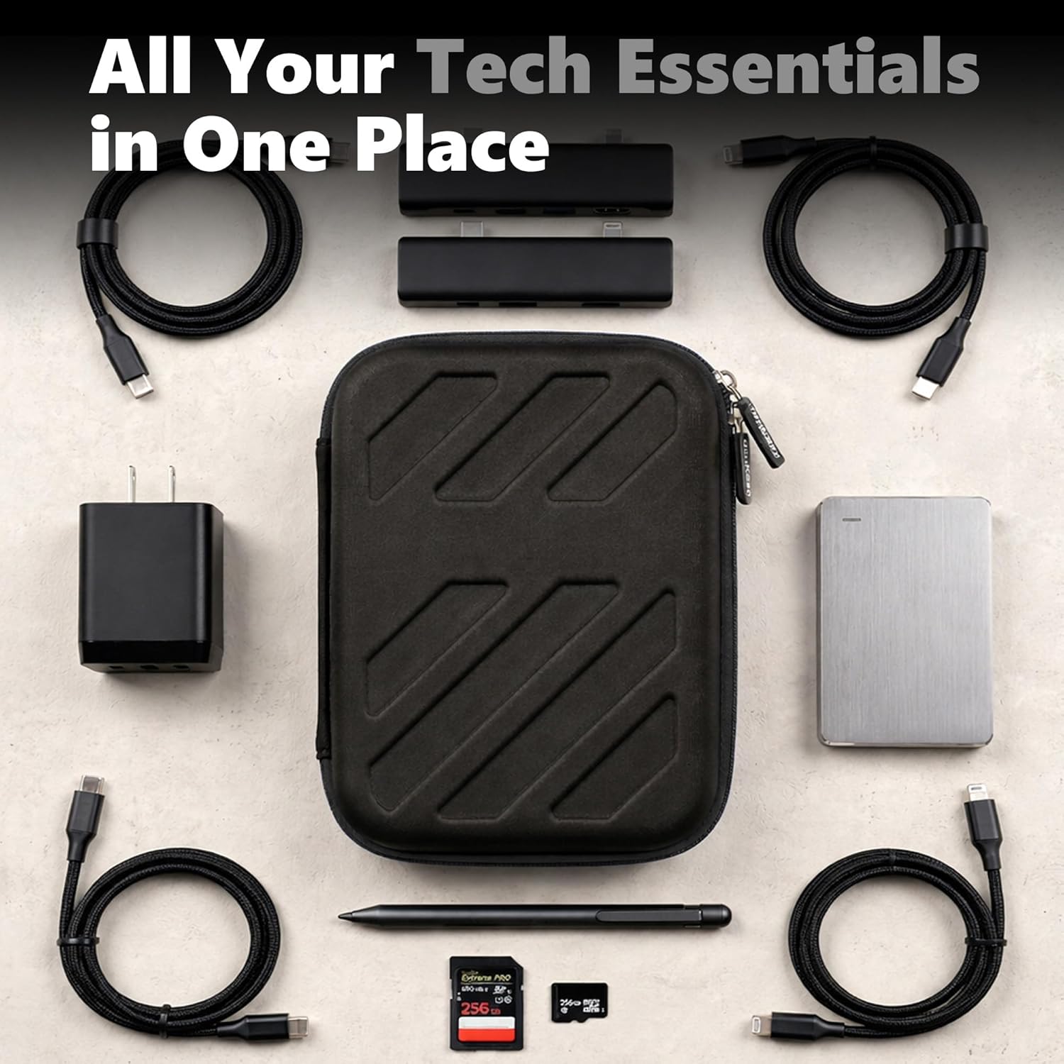hard case for tech essentials surrounded by charging cables, USB hub, portable SSD, charger, stylus, and memory cards