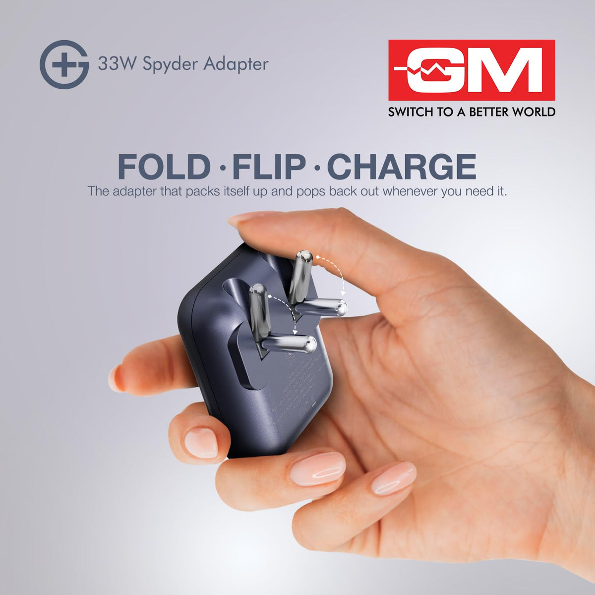 A hand holding a compact dark gray 33W Spyder Adapter plug, with promotional text and the GM Switch to a Better World logo on a light gray background.