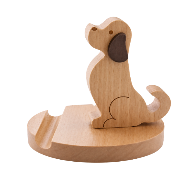 A small wooden dog-shaped object on a round wooden base, photographed on a clean white background. The dog appears to be a stylized cutout or decorative figure with a darker brown ear and engraved line details.