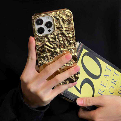 Close-up GRUNX Goldie gold iPhone case surface finish texture button cutouts premium build quality detail