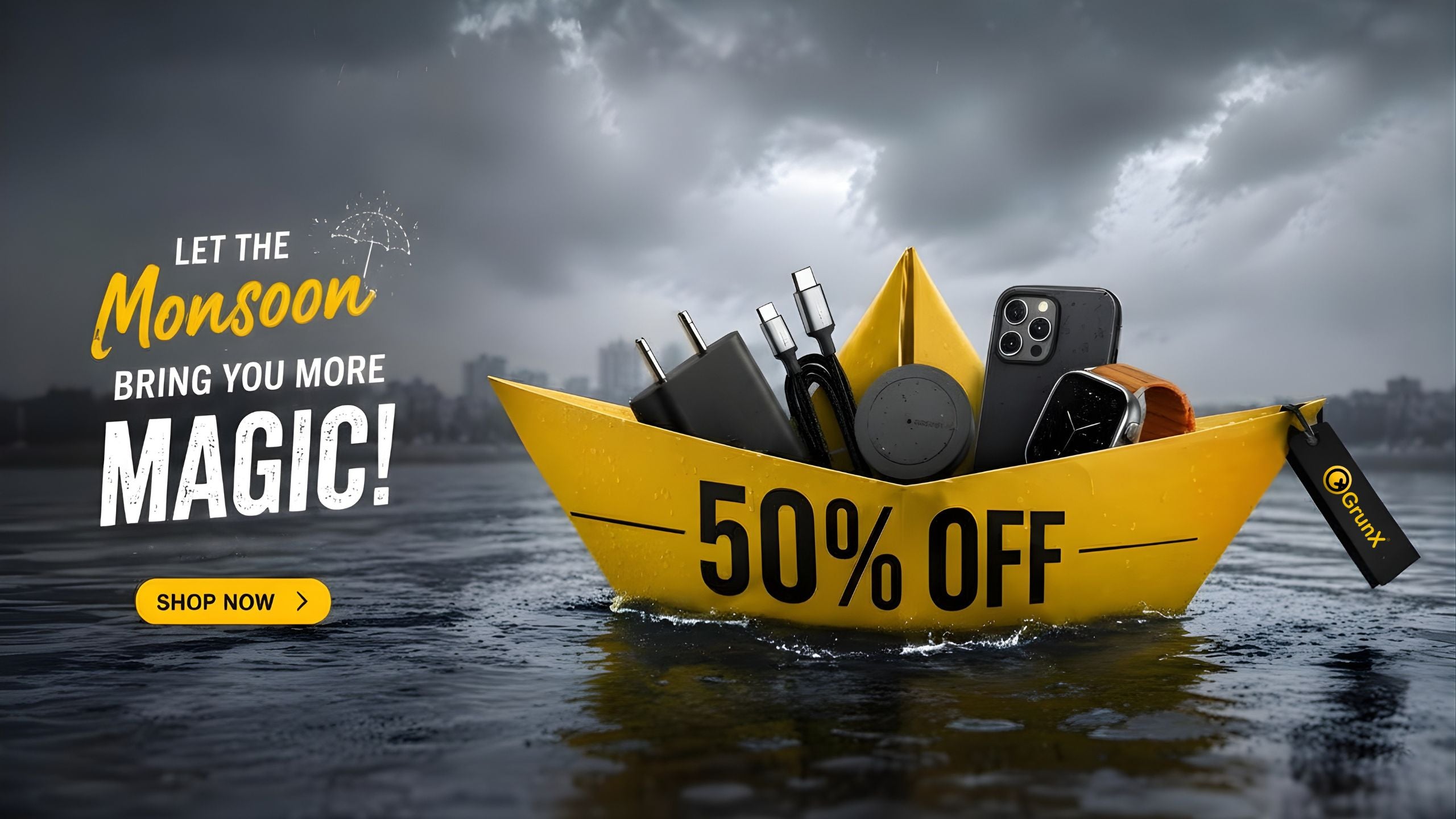 GrunX Monsoon Sale banner featuring a yellow paper boat floating on rainwater with premium mobile accessories including a fast charger, USB cables, wireless charger, iPhone, and smartwatch, highlighting up to 50% off offers during the monsoon season.