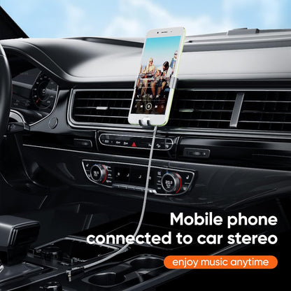 3.5mm right angle aux cable connecting smartphone on car vent mount to car stereo for music streaming while driving