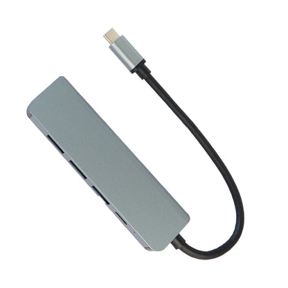 GRUNX Military Grade USB-C adapter 100W connected to MacBook Air M2 with monitor mouse and keyboard in Indian home office