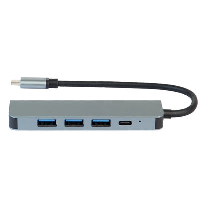 GRUNX Military Grade 7-in-1 shockproof metal USB-C hub adapter 100W with all ports labeled on clean desk with MacBook