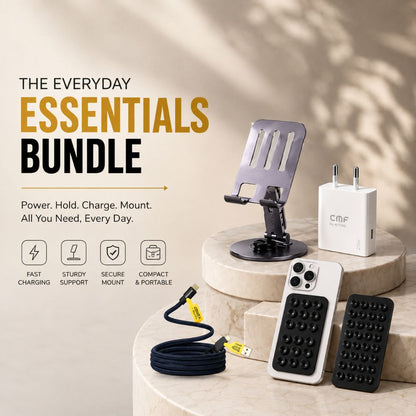A promotional bundle display for a phone accessories set on beige stone pedestals. The bundle includes a black phone stand, a white wall charger with the CMF logo, a black textured grip case, a white textured grip case, and a black cable with a yellow connector.