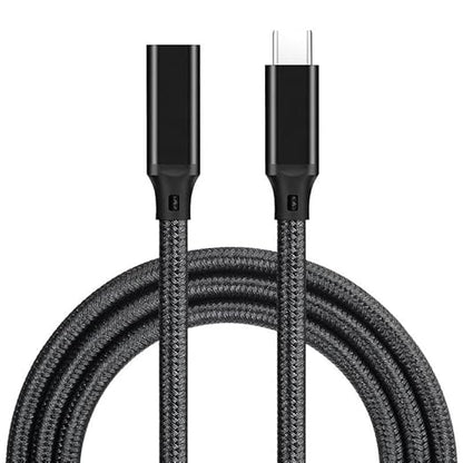 A black braided USB-C to USB-C charging cable coiled on a white background, showing the detailed texture of the woven outer layer and the metallic connector tips.