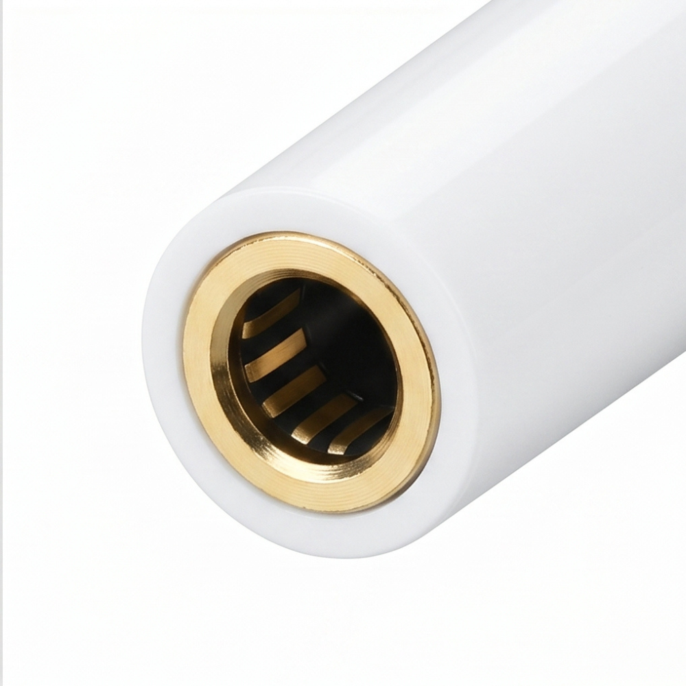 Close-up of white 3.5mm headphone jack port end of a USB-C audio adapter