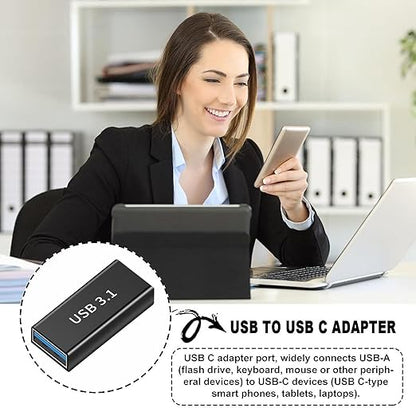 A woman at a desk holds a smartphone while using a laptop, with a circular inset showing a black USB-C adapter labeled USB 3.1.