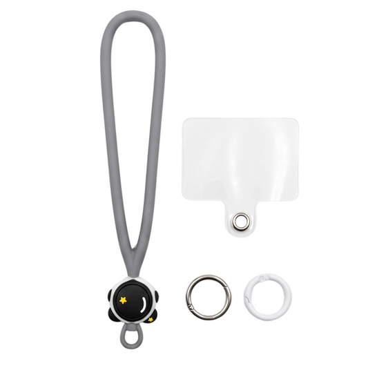 A gray silicone wrist strap with a black circular charm featuring a yellow crescent moon and star design, shown with three accessories: a clear plastic hook, a silver metal ring, and a white ring on a plain white background.