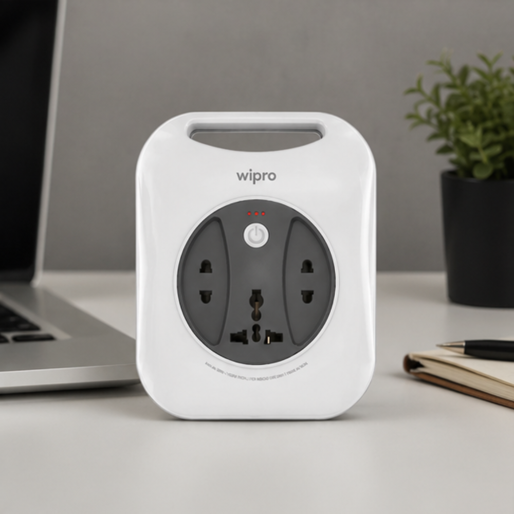 Wipro Flex Box universal multi-socket extension board standing upright on white office desk beside laptop