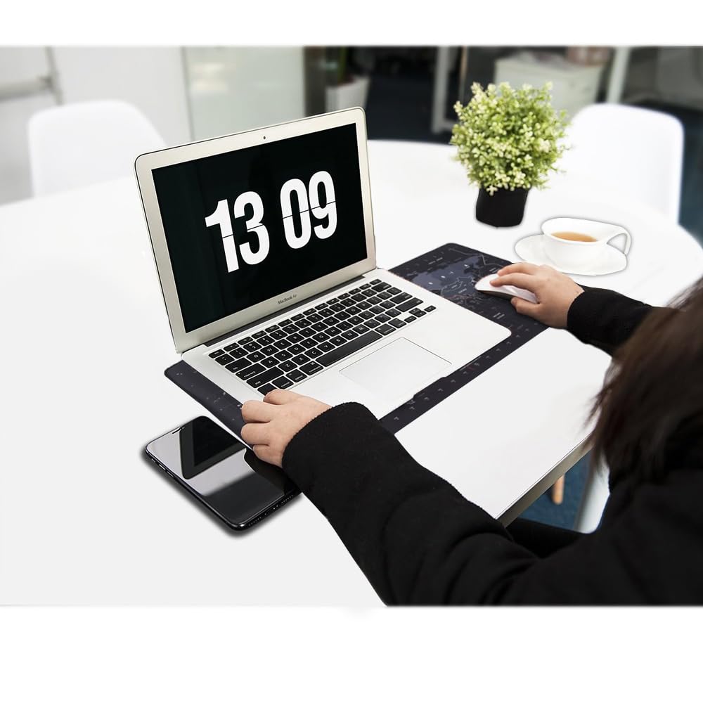 Large extended world map gaming mouse pad desk mat used by woman with MacBook laptop and smartphone on white office desk