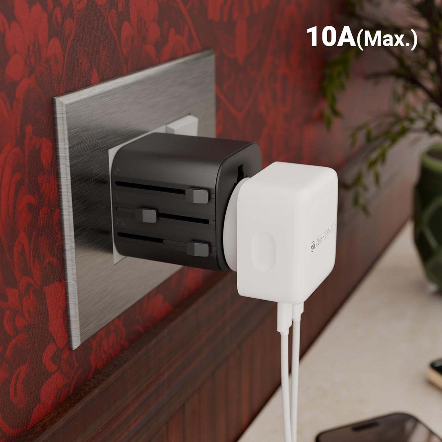 Zebronics TravMate 150 universal travel adapter plugged into wall socket rated 10A max with charger connected